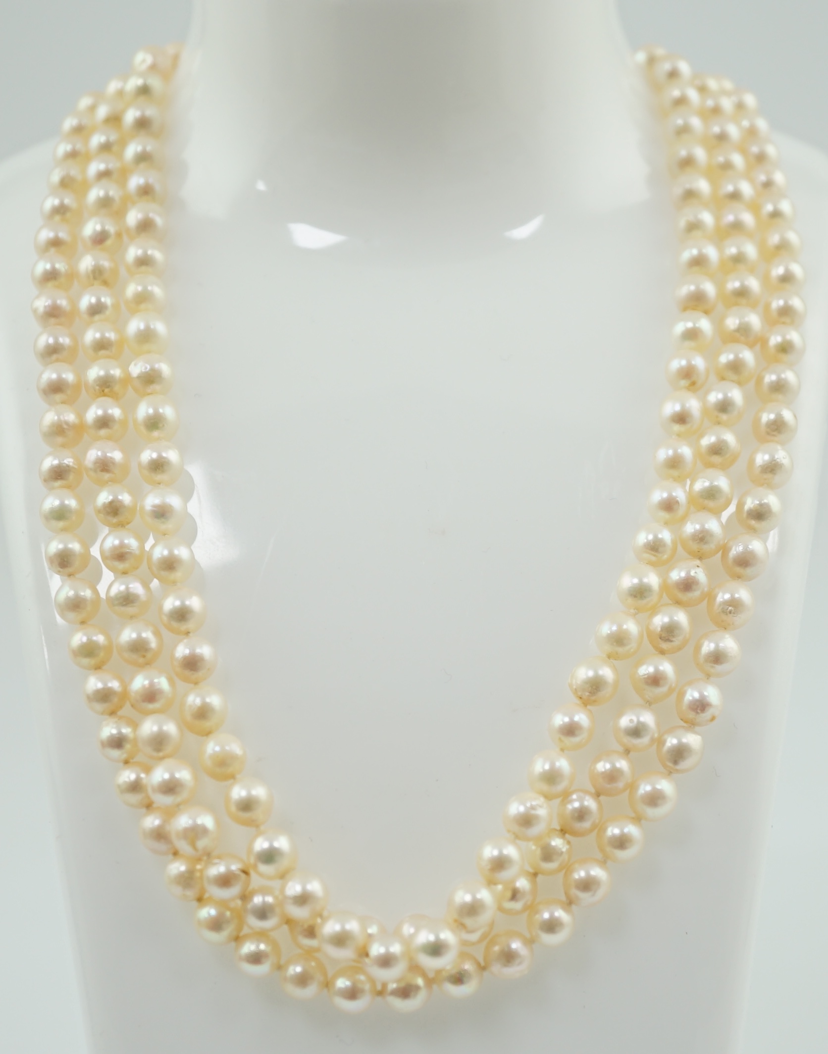 A modern triple strand cultured pearl choker necklace, with three stone diamond set 14k white gold clasp